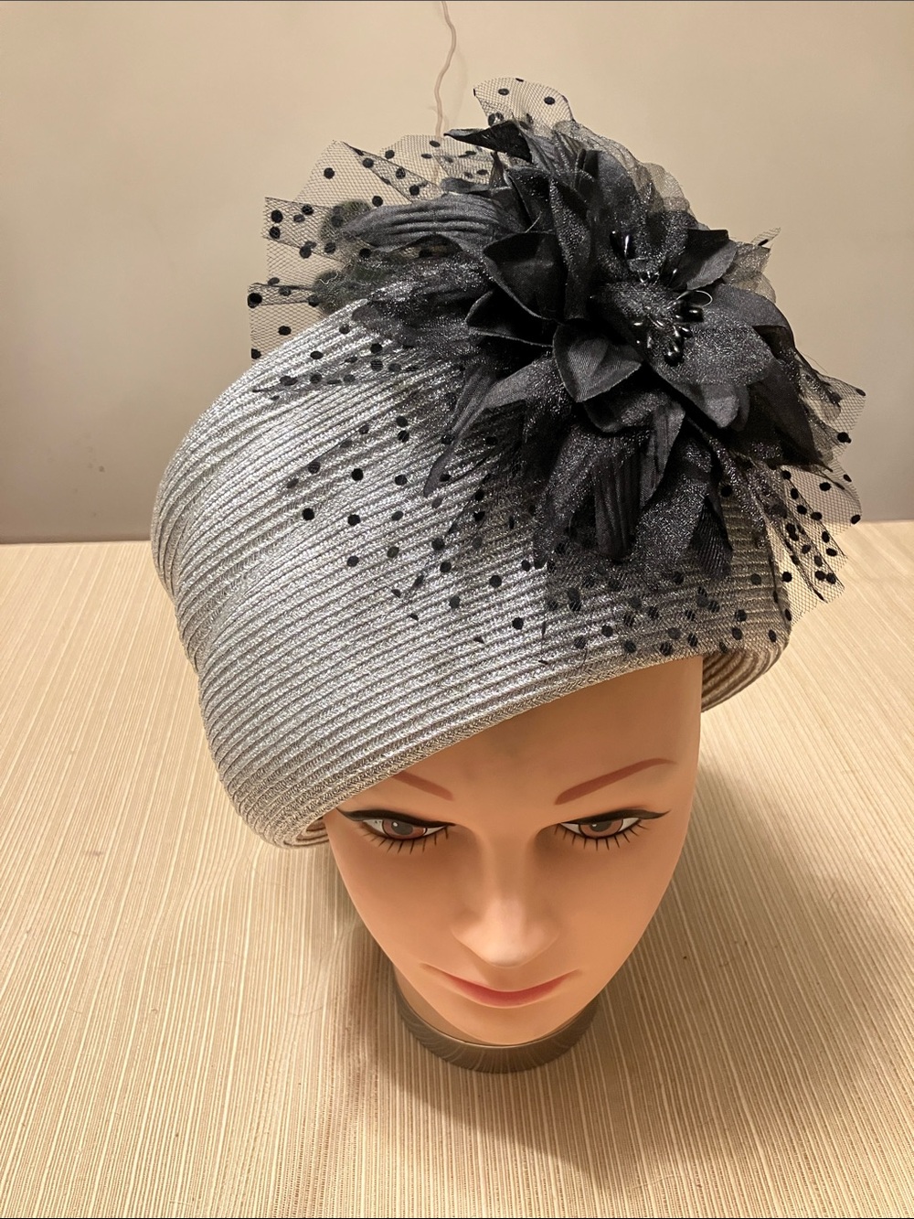 Elegant Metallic Silver Hat with Black Floral Accent